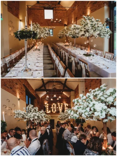 Elegant wedding reception setup, rustic brick venue with floral decor.
