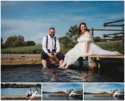 Bride and groom sitting on dock by lake.