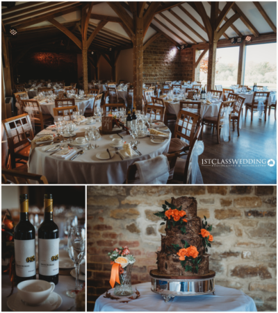 Elegant barn wedding venue setup with cake and decor.