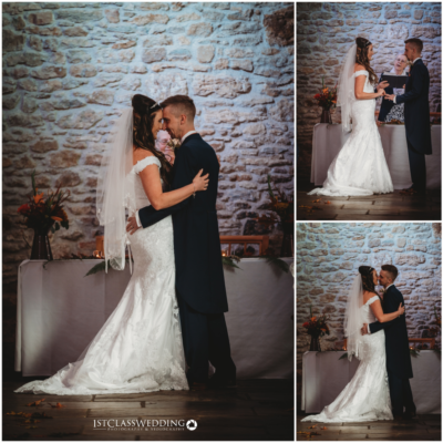 Bride and groom embracing at stone-wall venue.