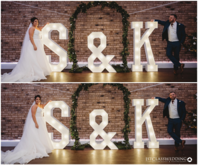 Bride and groom with illuminated initials at wedding.
