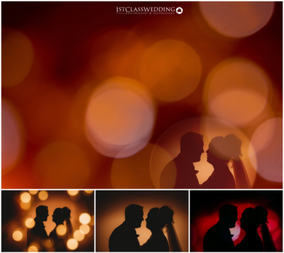 Silhouetted couple with warm bokeh lights background.