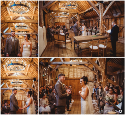 Rustic barn wedding ceremony with couple exchanging vows.