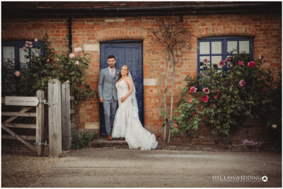 Couple posing at rustic manor wedding venue.