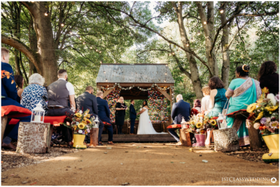 Outdoor woodland wedding ceremony scene.