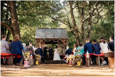 Outdoor wedding ceremony in a forest setting.