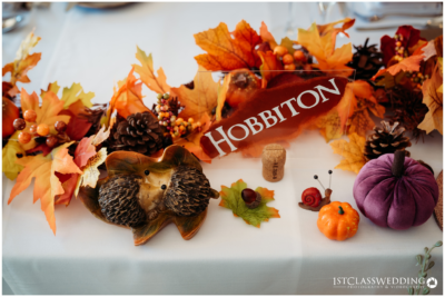 Autumn-themed table decor with "Hobbiton" sign.