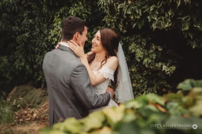 Couple laughing together at wedding outdoors