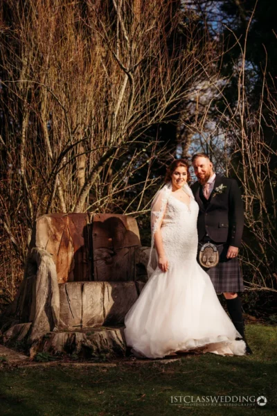 Bride and groom outdoors with Scottish kilt and white dress.