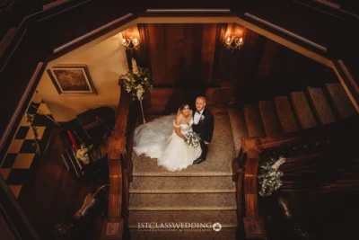 Couple posing on stairs at wedding venue.