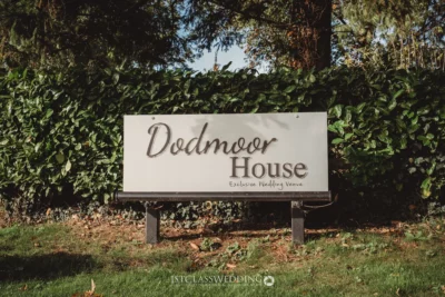 Dodmoor House sign, exclusive wedding venue with greenery.
