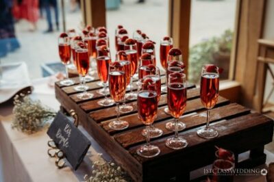 Champagne glasses with strawberries on wedding reception table.