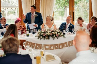 Wedding reception speech with smiling guests