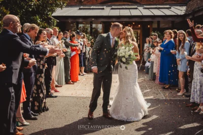 Bride and groom kissing, confetti, wedding celebration