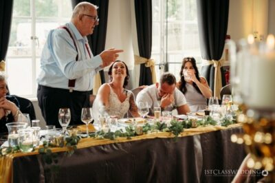 Wedding speech with laughing bride and guests.