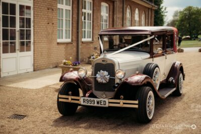 Vintage car decorated for wedding outside venue