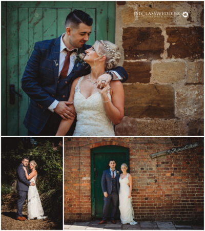 Newlyweds posing by rustic brick wall and vintage door.