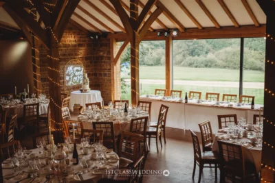 Rustic wedding venue interior with decorated tables.
