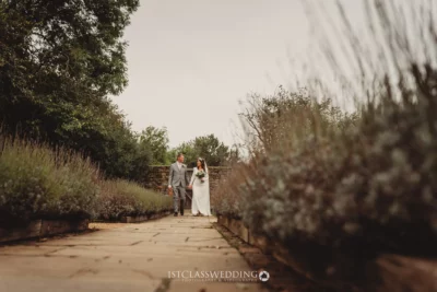 Couple walking in garden at their wedding