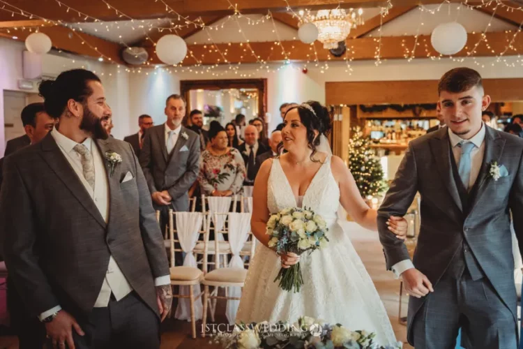 Bride, groom, and guests at indoor wedding ceremony.