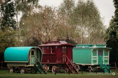 Colourful vintage caravans on grassy field.