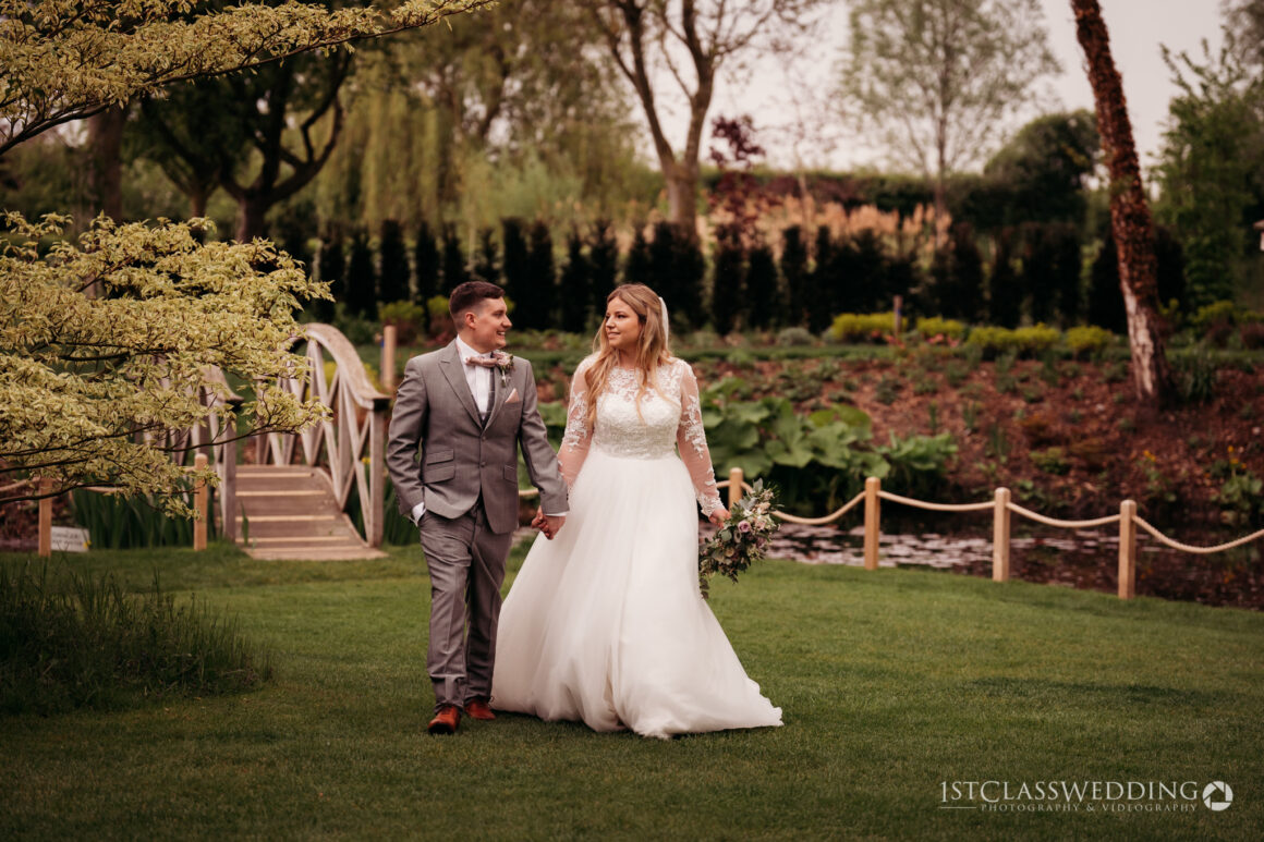 bride and groom walking in garden at south farm