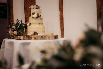 Elegant wedding cake with floral decorations on display.