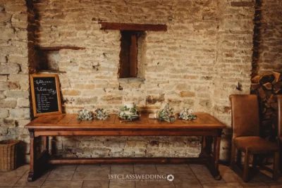 Rustic wedding welcome table with schedule chalkboard.