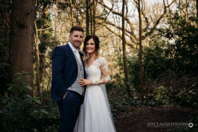 Wedding couple posing in forest setting.