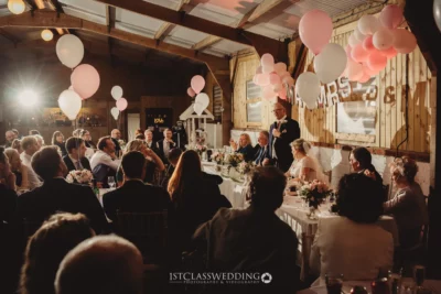 Rustic wedding reception speech moment with guests.