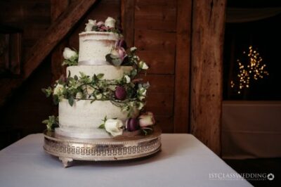 Elegant three-tier wedding cake with floral decoration.