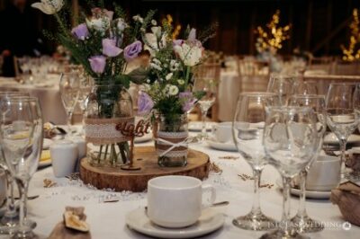 Rustic wedding table setting with floral centrepiece.