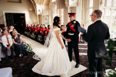 Bride and groom wedding ceremony with military uniform.