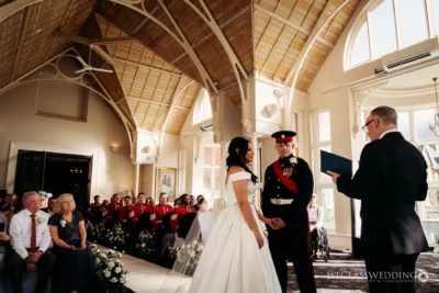 Military wedding ceremony in elegant hall.