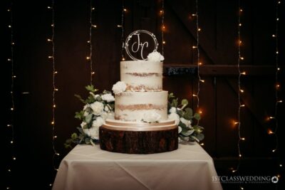 Elegant wedding cake with fairy lights background.