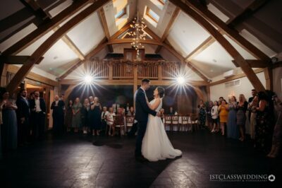 Couple's first dance at rustic wedding hall.