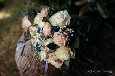 Elegant wedding bouquet on rustic wooden surface.