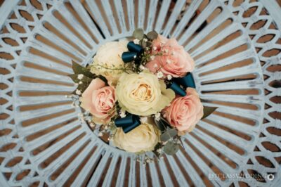 Floral wedding bouquet on white patterned table.