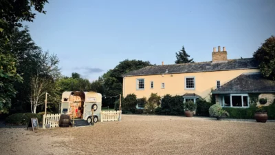 Country house with vintage caravan food stall.