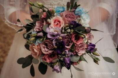 Bride holding colourful wedding bouquet