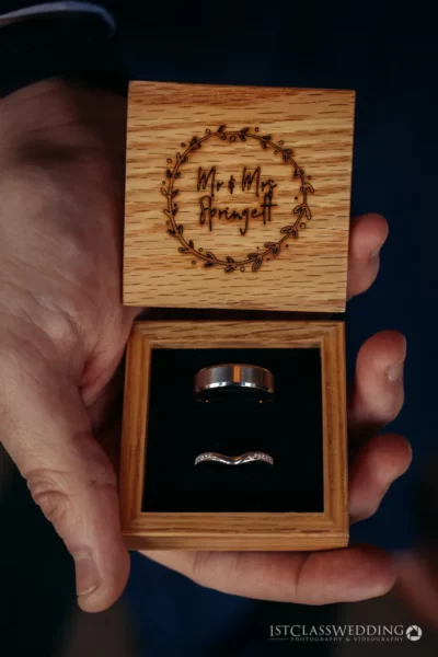 Wooden wedding ring box held in hand