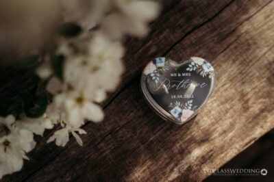 Heart-shaped wedding keepsake with date on wooden surface.