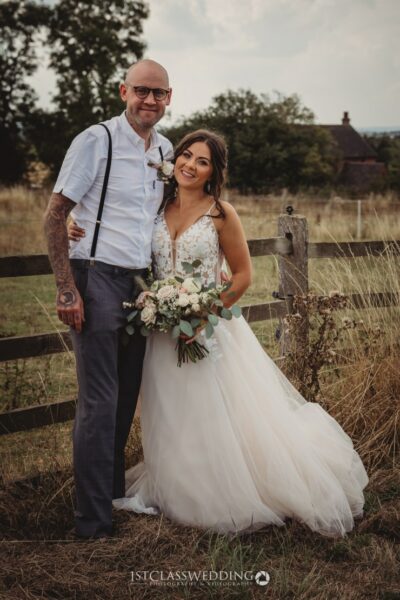 Happy couple at rustic countryside wedding.