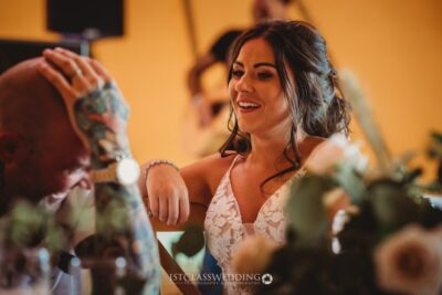 Bride smiling at wedding reception.
