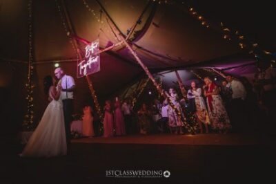Wedding first dance under tent with fairy lights