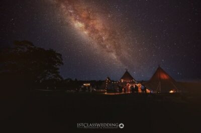Tented event under starry night sky.