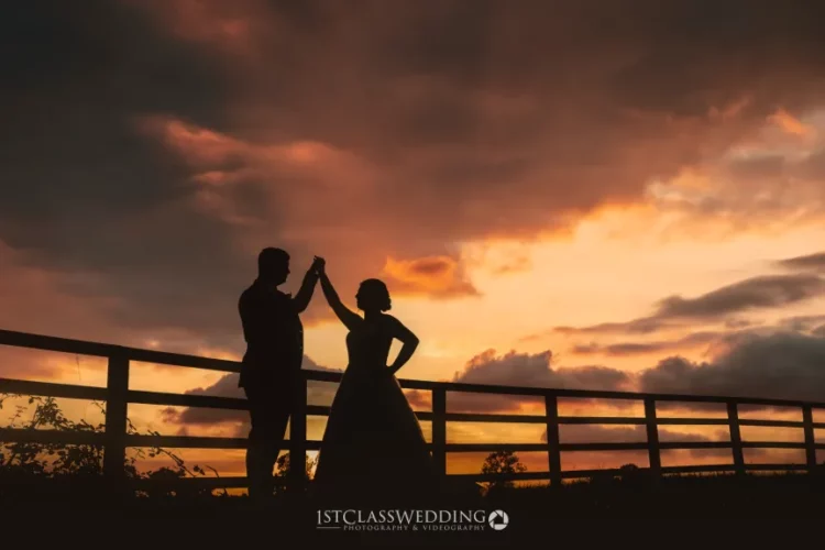 Silhouetted couple at sunset, romantic wedding photography.
