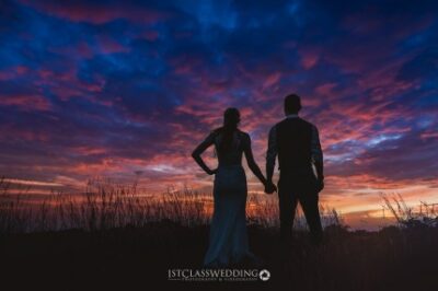 Couple silhouette during sunset at wedding.