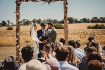 Outdoor wedding ceremony in a field.