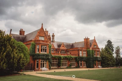 Elegant Victorian manor house with lush garden.
